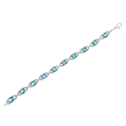 White metal bracelet with blue cushion-shaped gemstones and small round white gemstones in prong settings, shown flat from a top angle.