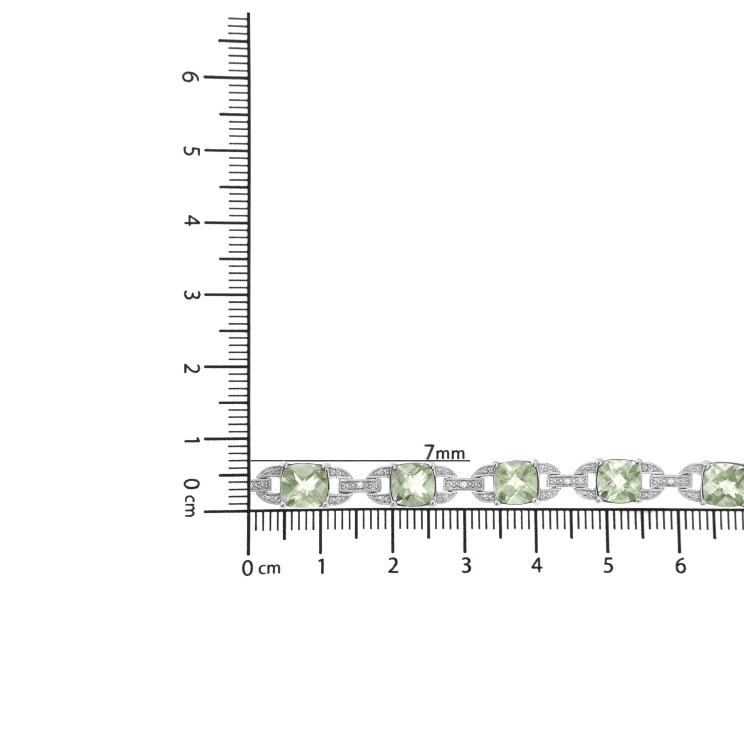 White metal bracelet with green cushion-shaped gemstones and small round white gemstones in prong settings, displayed on a ruler for size reference, shot from above.
