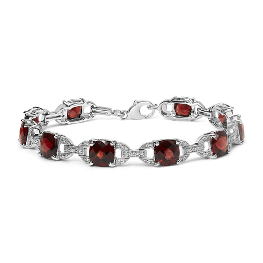 White metal bracelet with alternating red cushion-shaped gemstones and small round white gemstones in prong settings, shown from a front angle.