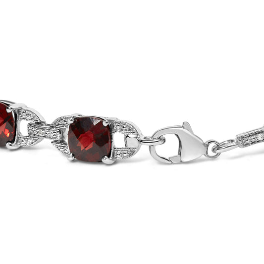 Close-up side angle of a white metal bracelet featuring cushion-shaped red gemstones and round white gemstones in prong settings, with a lobster claw clasp.