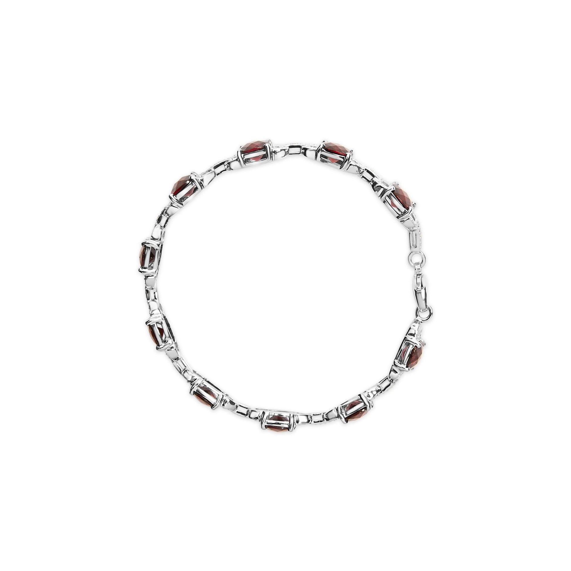 Top view of a white metal bracelet featuring alternating red cushion-shaped gemstones and round white gemstones in prong settings.