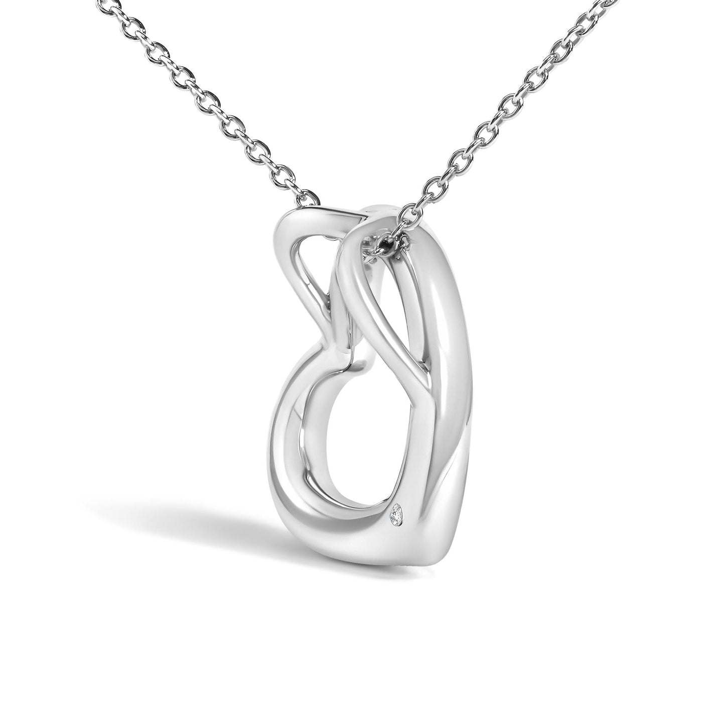 Close-up front angle of a white metal necklace with interlocking loops and a small round white gemstone in bezel setting near the bottom loop.