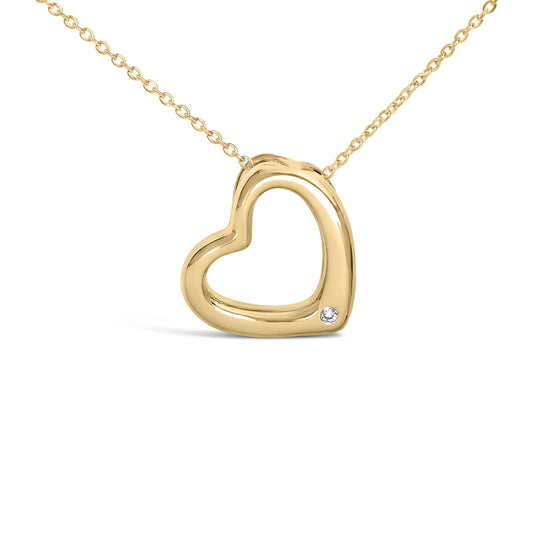 Close-up view of a yellow metal heart-shaped necklace pendant with an open center and a single round white gemstone set in the bezel near the bottom right, shown on a white background.