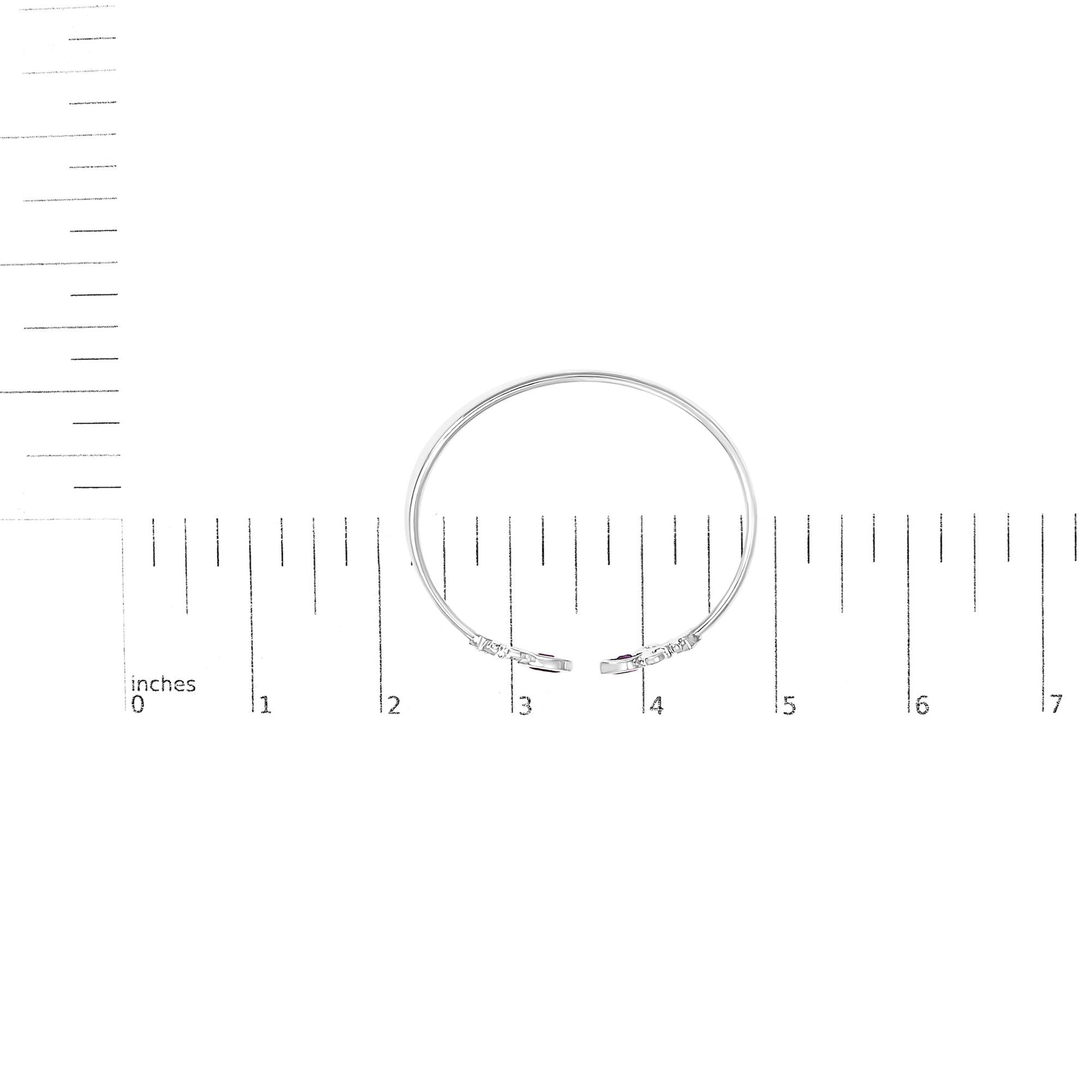 White-colored bracelet with two open ends, each end featuring a purple marquise-shaped gemstone in bezel setting surrounded by small round white gemstones in pave setting, shown on a measurement scale, top-down view.