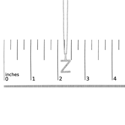 Close-up front view of a white necklace with a 'Z' shaped pendant covered in small white gemstones, shown on a ruler scale.