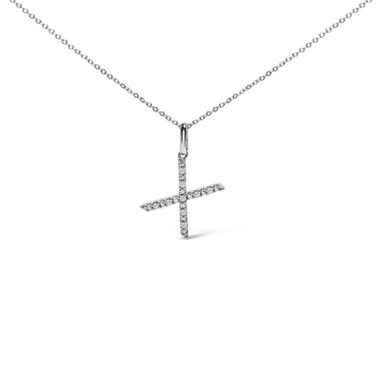 Close-up front angle of a white necklace with a pendant in the shape of a cross, featuring round white gemstones in a micro-pave setting.