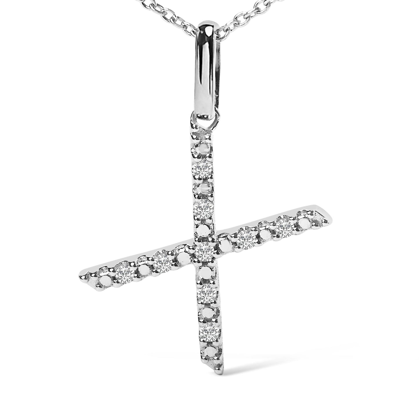 Close-up front angle of a white metal necklace pendant in the shape of a cross, adorned with round white gemstones set in a micro-pave style.