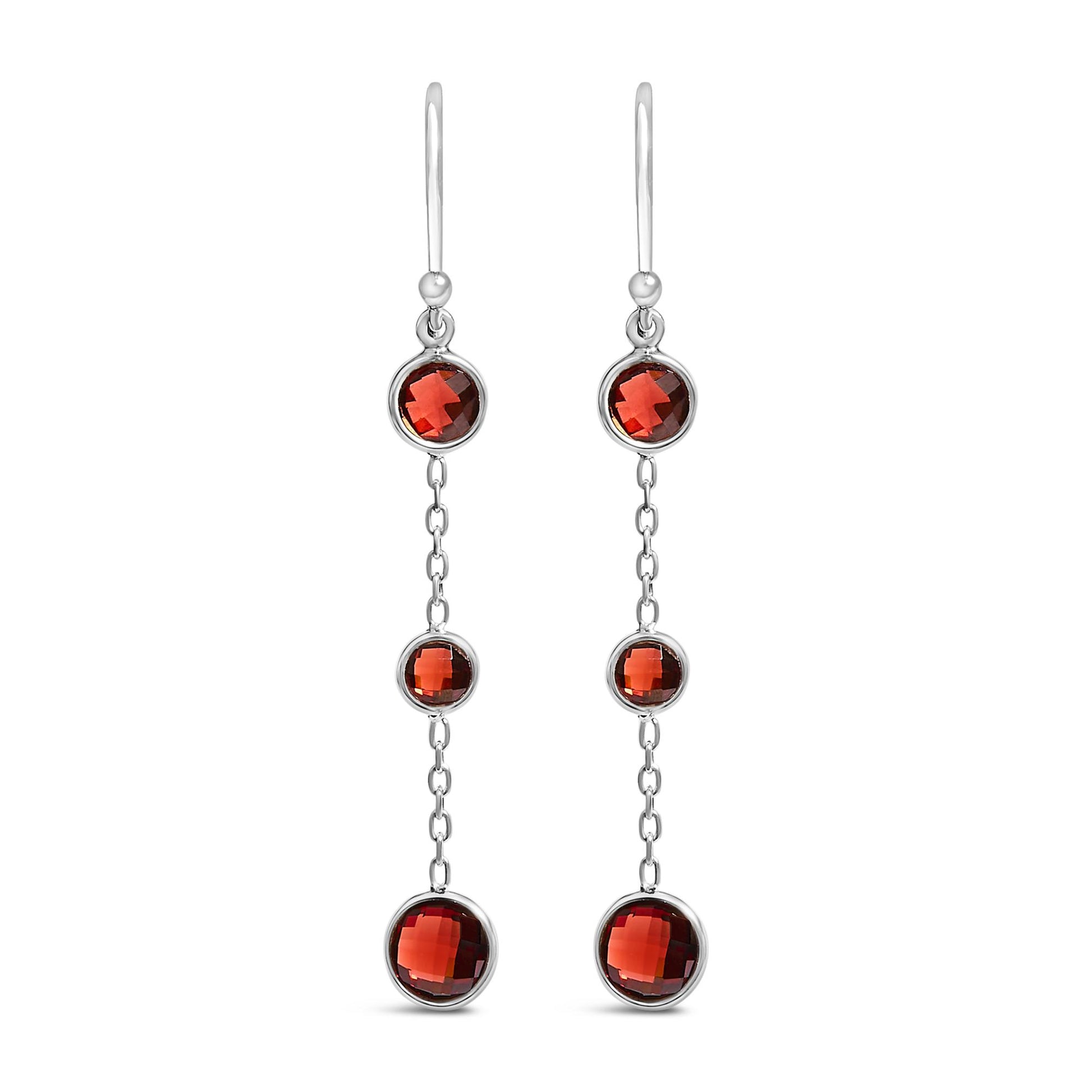 Pair of white metal drop earrings with three bezel-set round red gemstones connected by delicate chain links, shown in a front-facing view on a white background.