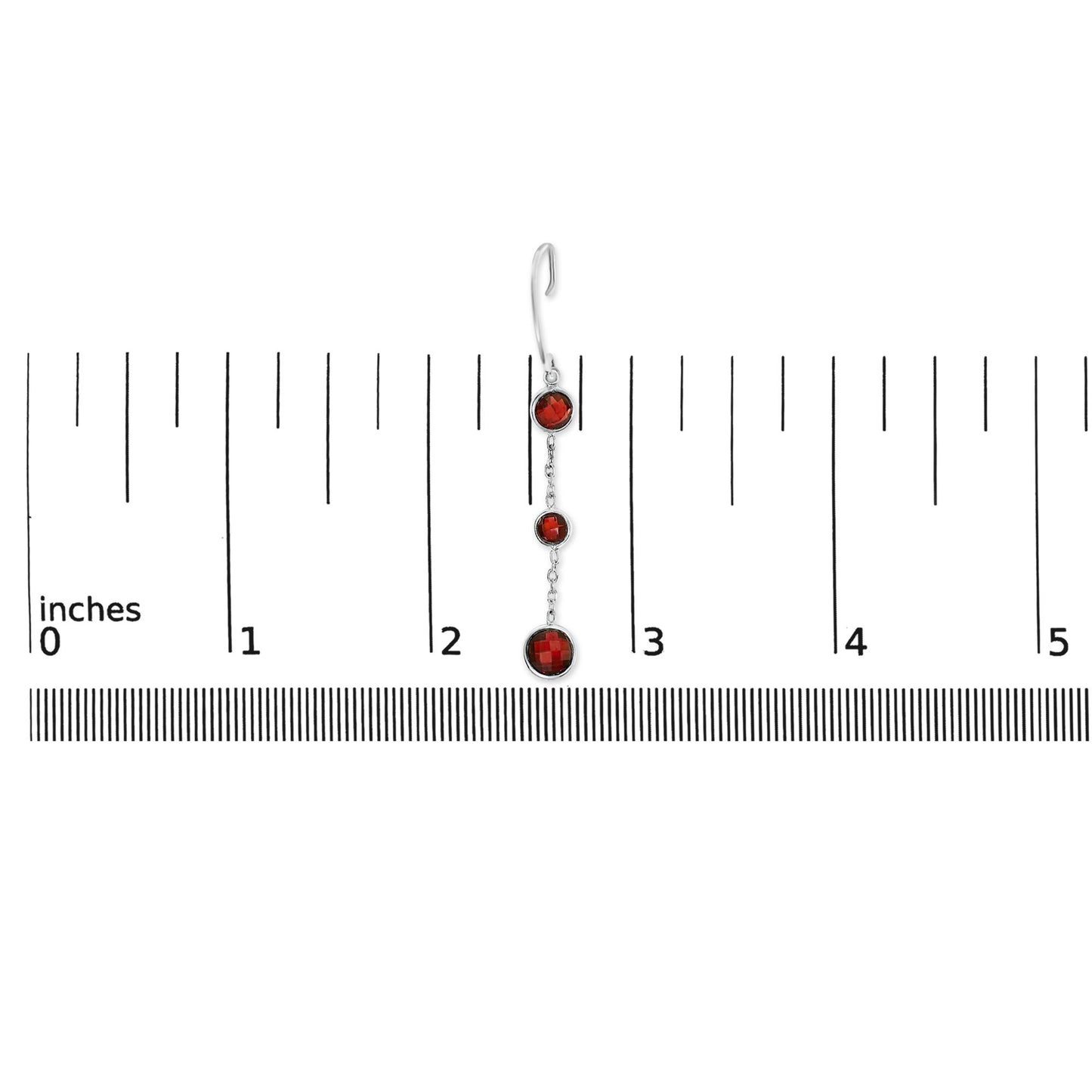 Single white metal earring with three round red gemstones in bezel settings, shown on a ruler for scale, photographed from the front.
