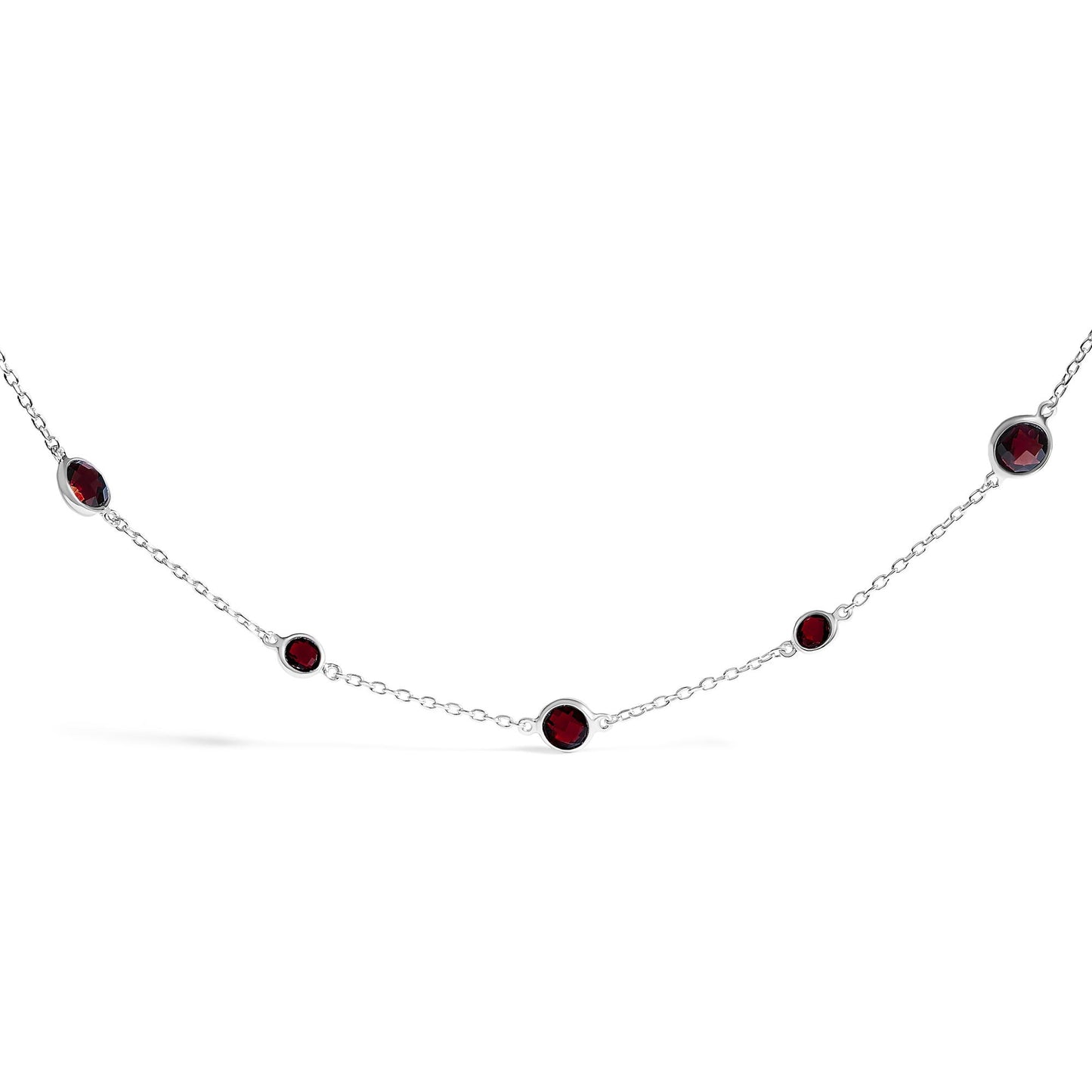 White metal necklace with round red gemstones in bezel settings, shown in a front-facing close-up shot.