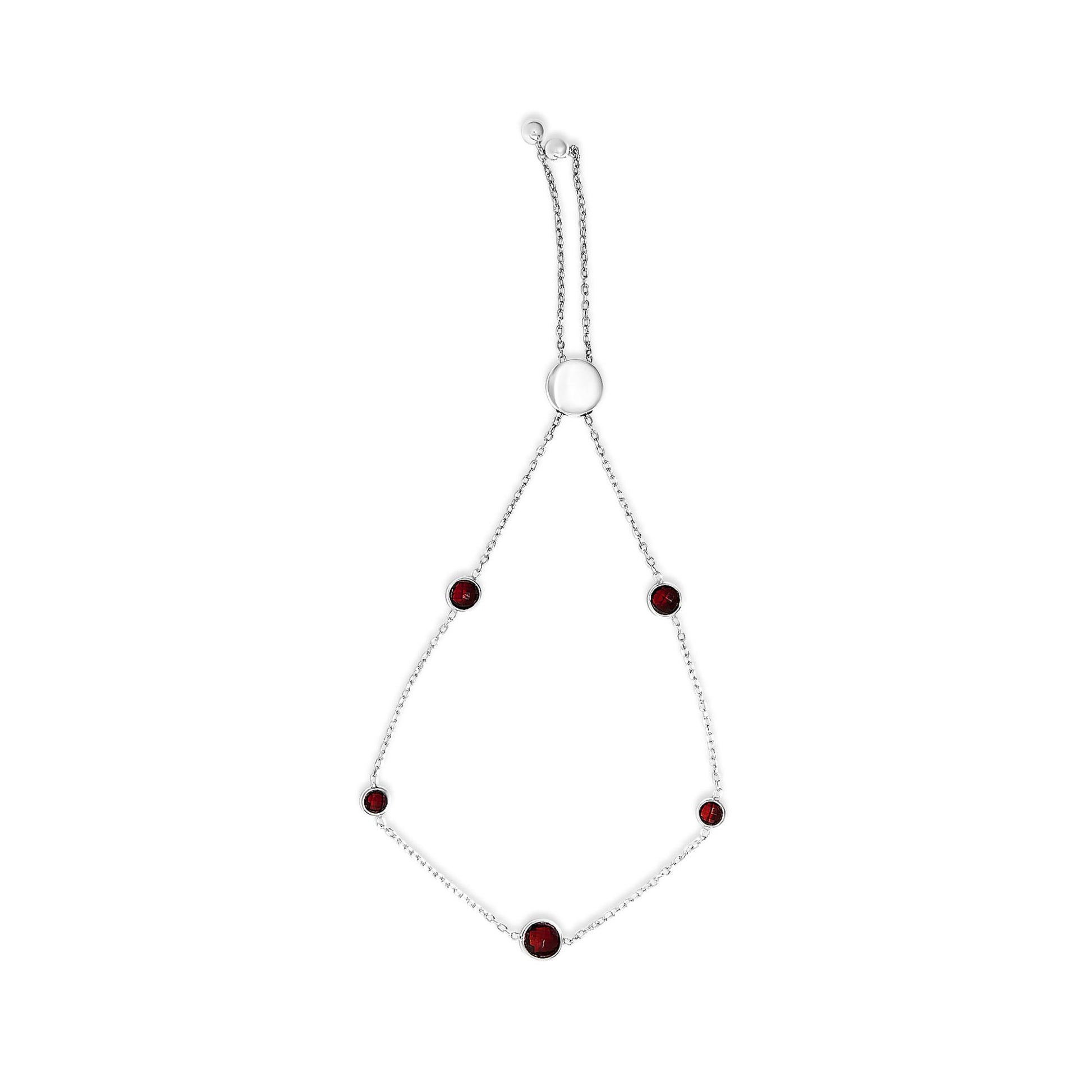 White bracelet with multiple round red gemstones in bezel settings, shown flat on a white background from a top-down angle.