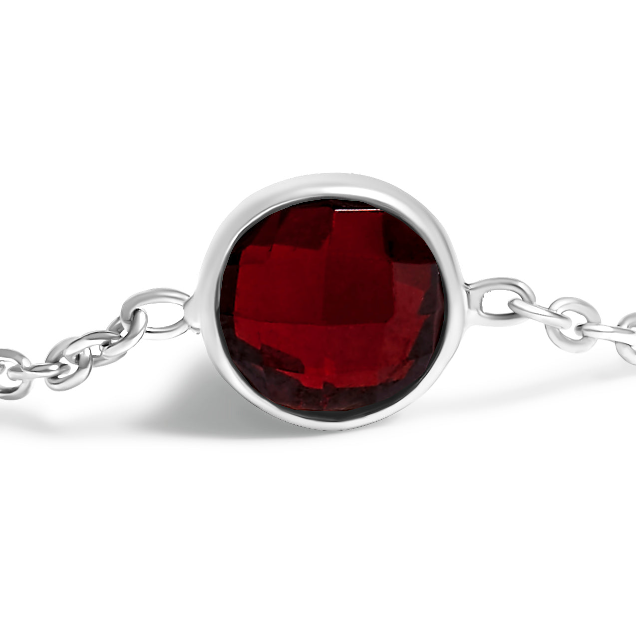 Close-up front view of a white metal bracelet with a round red gemstone in bezel setting, showing part of the chain on a white background.