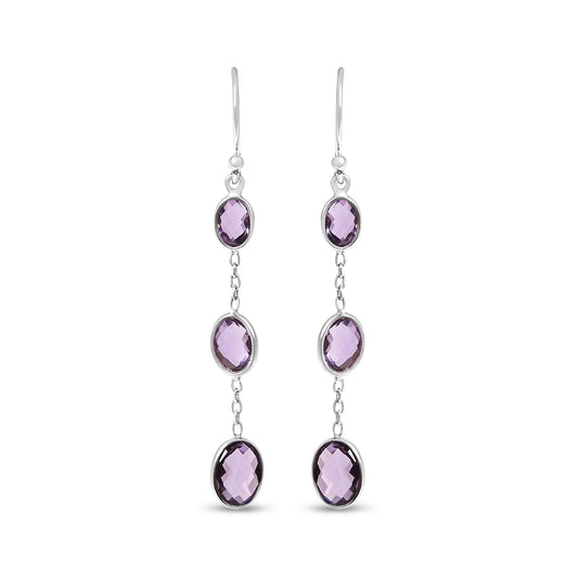 Front view of white metal dangle earrings featuring three oval purple gemstones in bezel settings connected by small links.