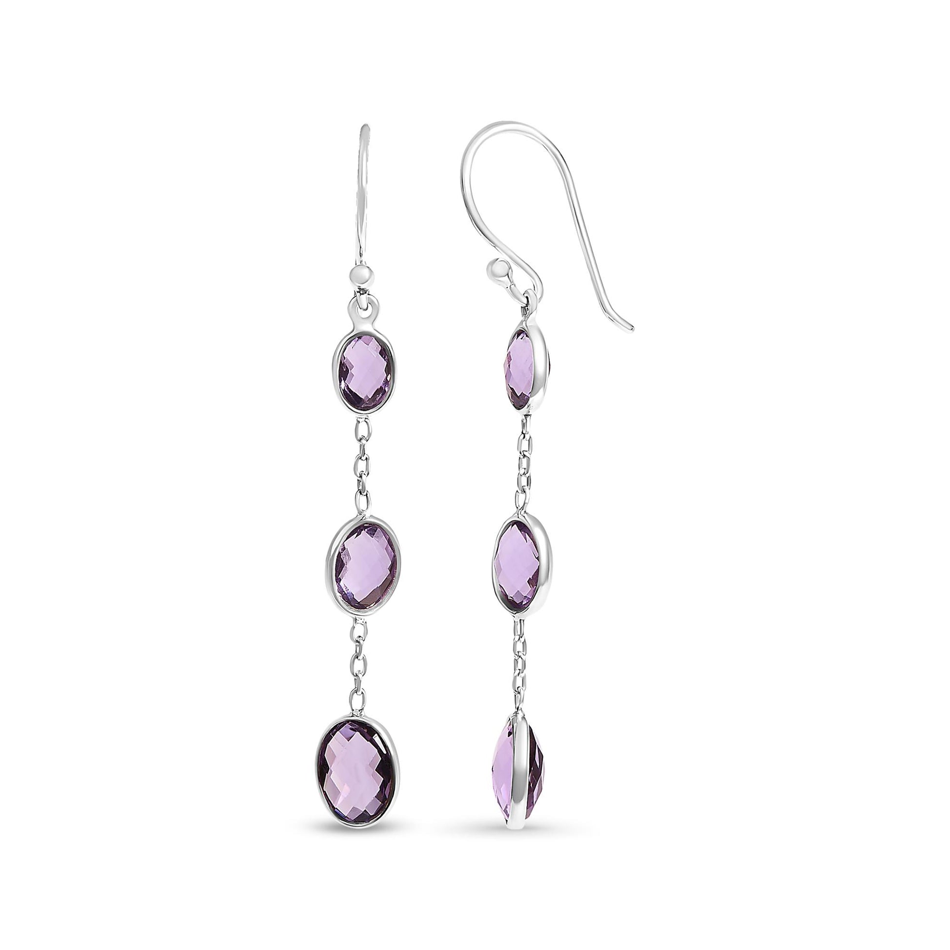 Pair of white metal dangle earrings with three oval purple gemstones in bezel settings, shown from front and side angles.