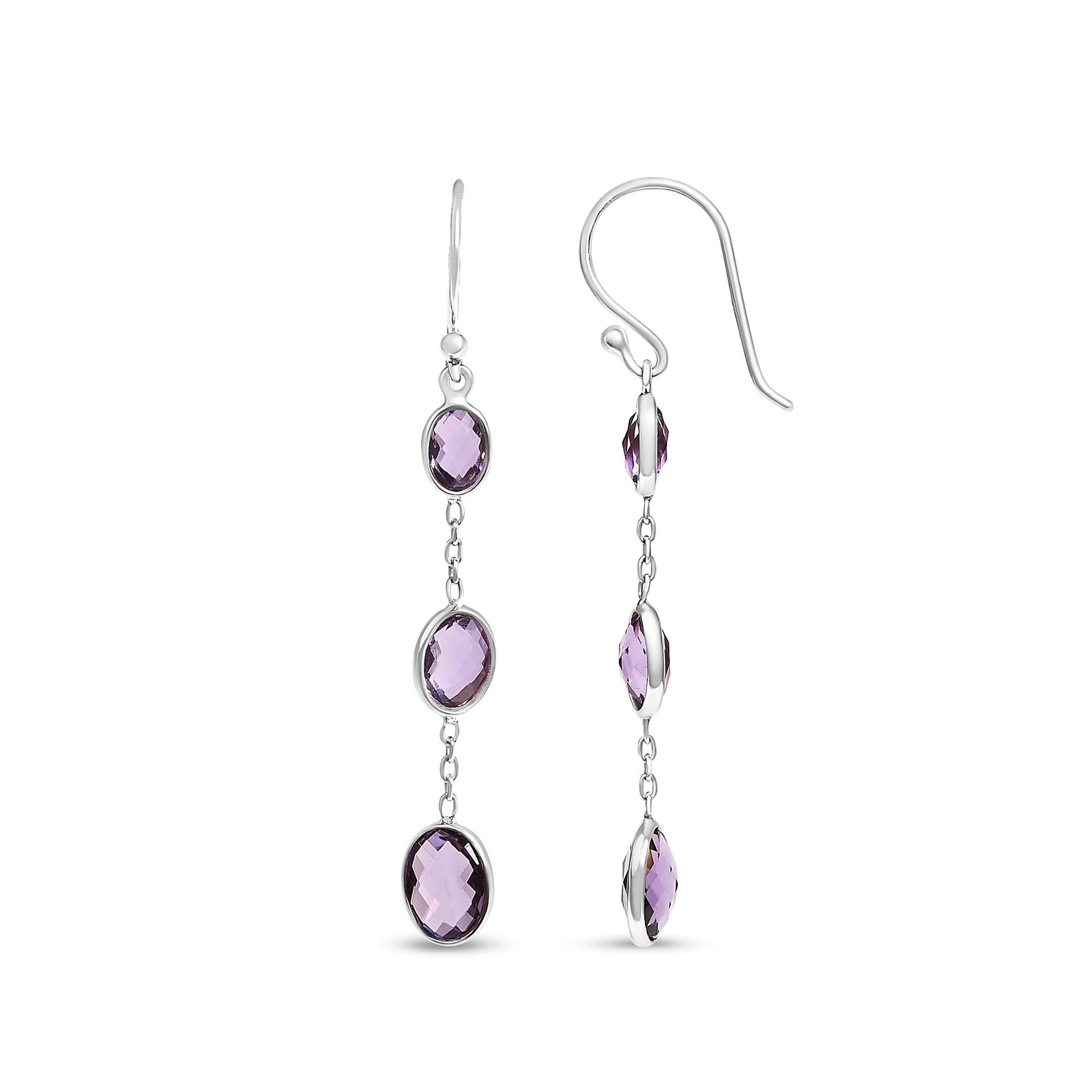 Front and side view of white metal drop earrings featuring three oval purple gemstones in bezel settings connected by small links.