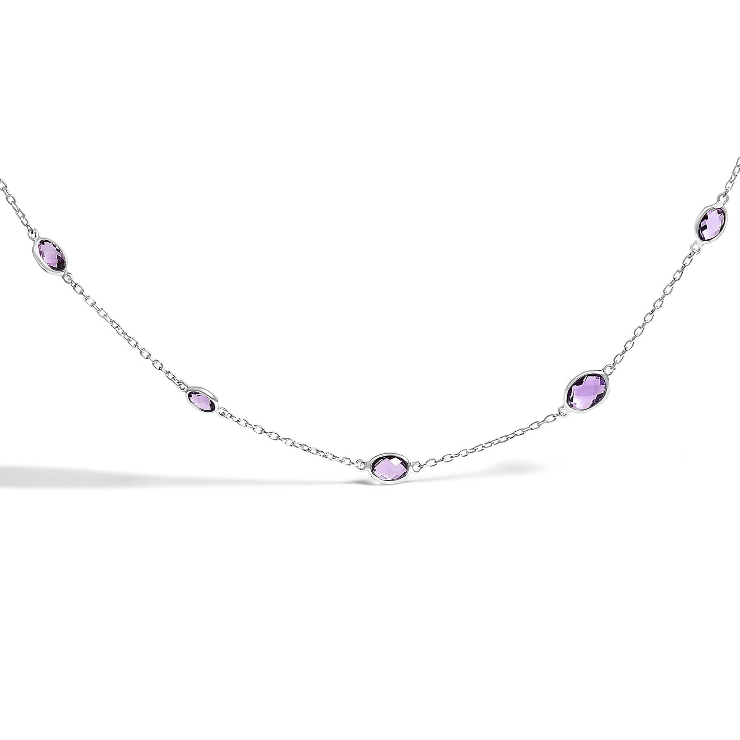 Close-up front angle of a white necklace featuring multiple purple oval bezel-set gemstones evenly spaced along a delicate chain.