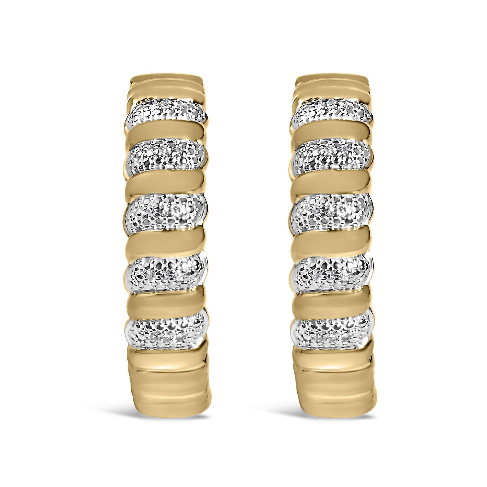 Close-up front view of a pair of yellow metal earrings featuring alternating smooth bands and sections paved with round white gemstones.