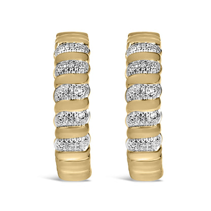 Close-up front view of a pair of yellow metal earrings featuring alternating smooth bands and sections paved with round white gemstones.