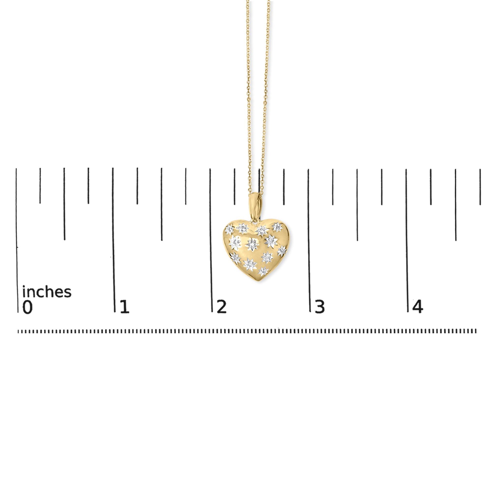 Close-up front of gold vermeil heart pendant necklace showcasing 1/10 cttw diamond star accents with inch ruler for scale