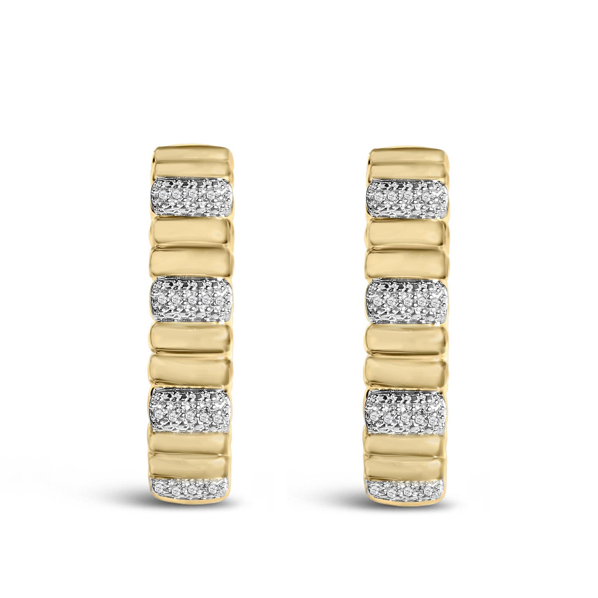 Front view of gold vermeil ribbed hoop earrings with 1/10 cttw diamonds alternating with smooth gold sections on white background