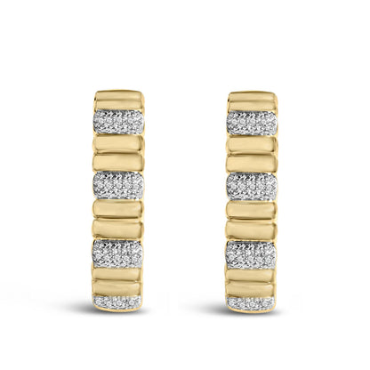 Front view of gold vermeil ribbed hoop earrings with 1/10 cttw diamonds alternating with smooth gold sections on white background