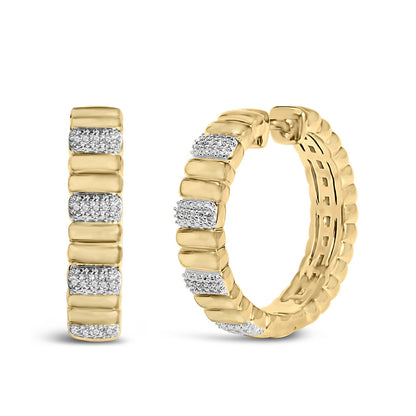 Close-up front and side view of pair of yellow metal hoop earrings with sections of white gemstones in prong setting.