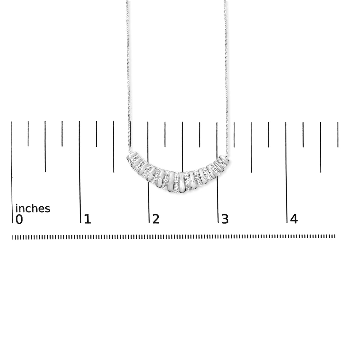 Close-up front view of a white necklace chain with a crescent-shaped pendant featuring alternating smooth segments and segments set with small white gemstones, shown on a measuring scale.