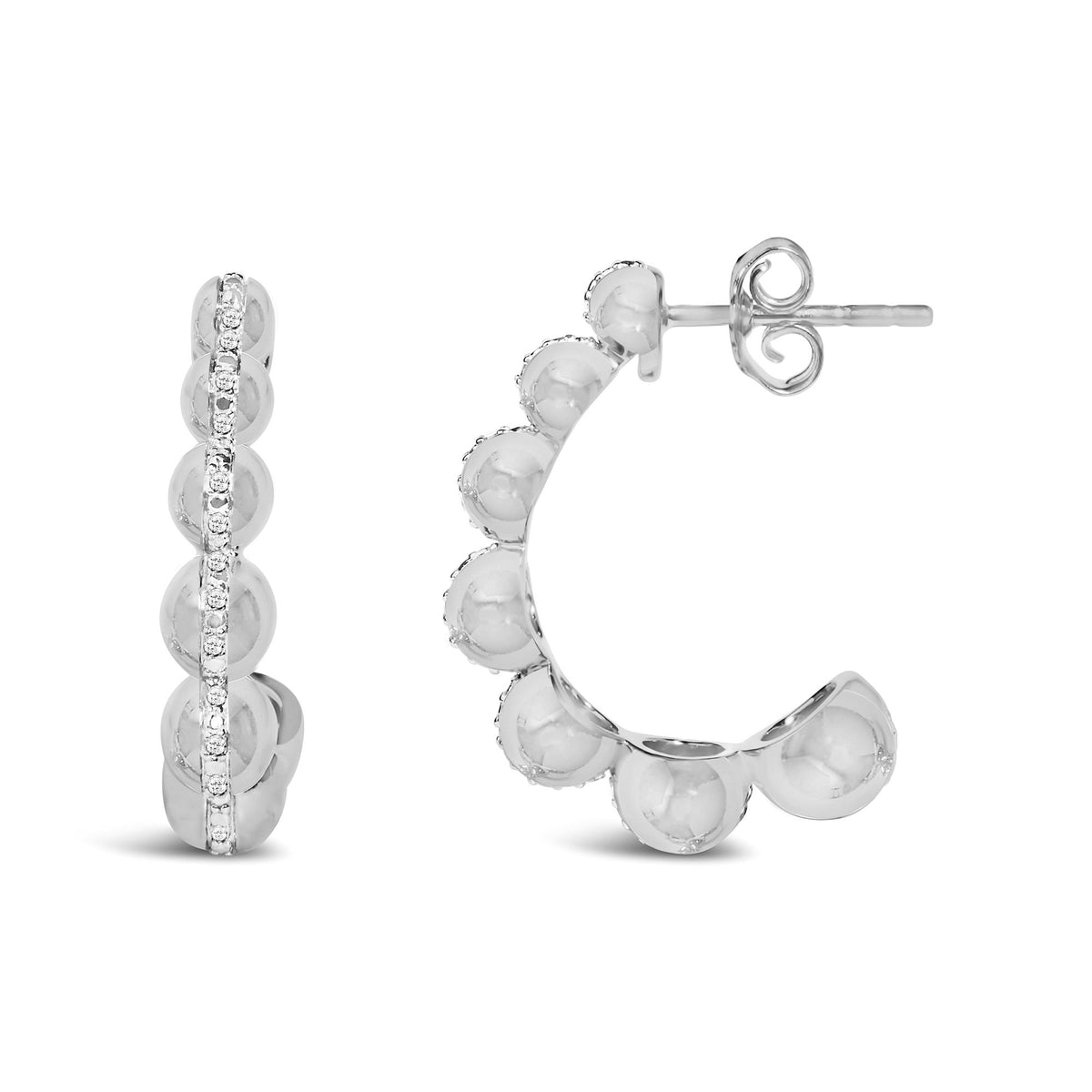 Close-up front and side view of a pair of white metal hoop earrings with round white gemstones in a pave setting along the front.