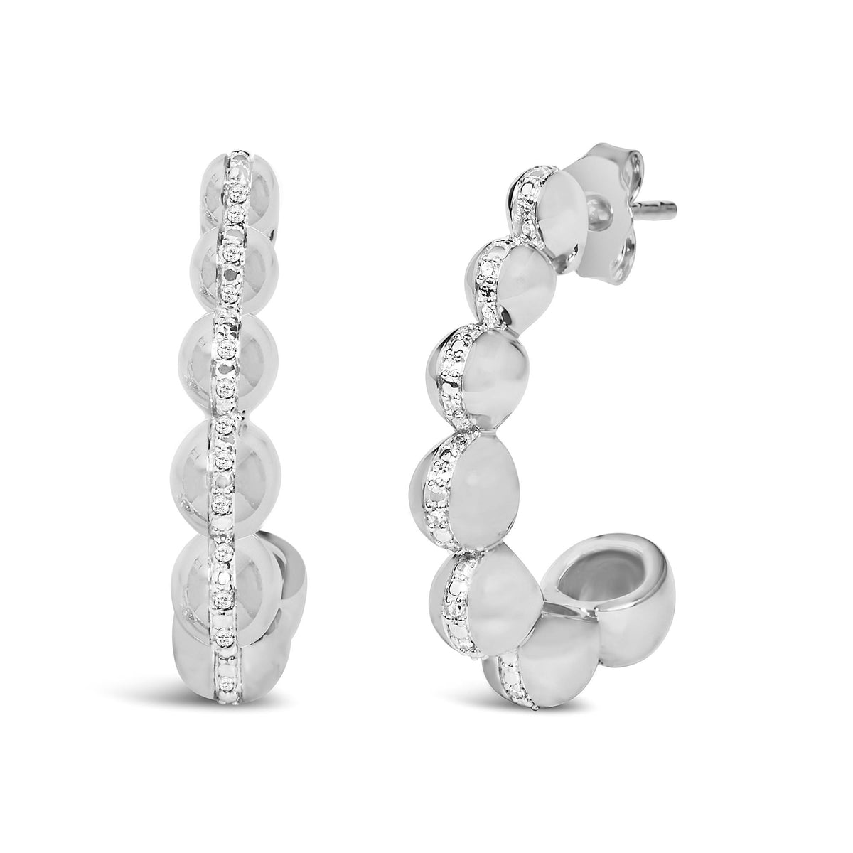 Close-up front and side view of white metal earrings with rounded forms and a central row of white gemstones in a pave setting.