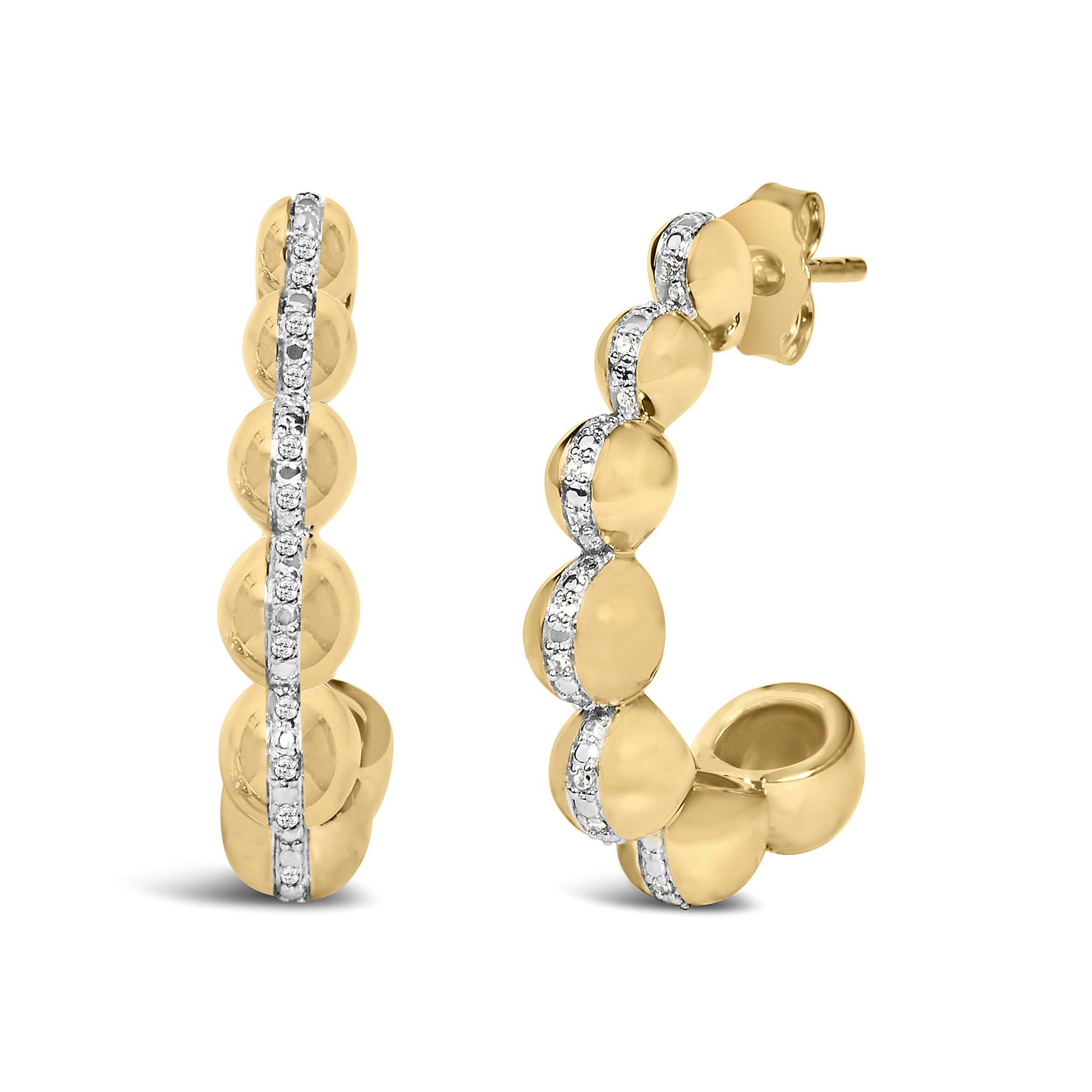 Close-up front and side view of yellow metal earrings featuring a row of white gemstones in a pave setting along the center.