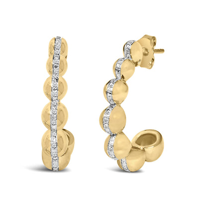 Close-up front and side view of yellow metal earrings featuring a row of white gemstones in a pave setting along the center.
