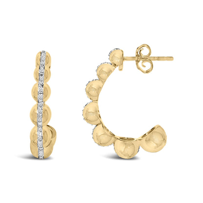 Close-up side angle of a yellow metal hoop earring with round shape showing a front view and a partial side view; the earring features a vertical row of white gemstones in a pave setting down the front.