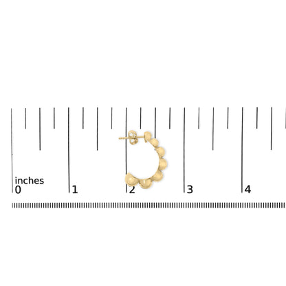 Yellow metal half-hoop earrings with rounded bead shapes along the outer edge, shown on a measurement scale, top-down angle.