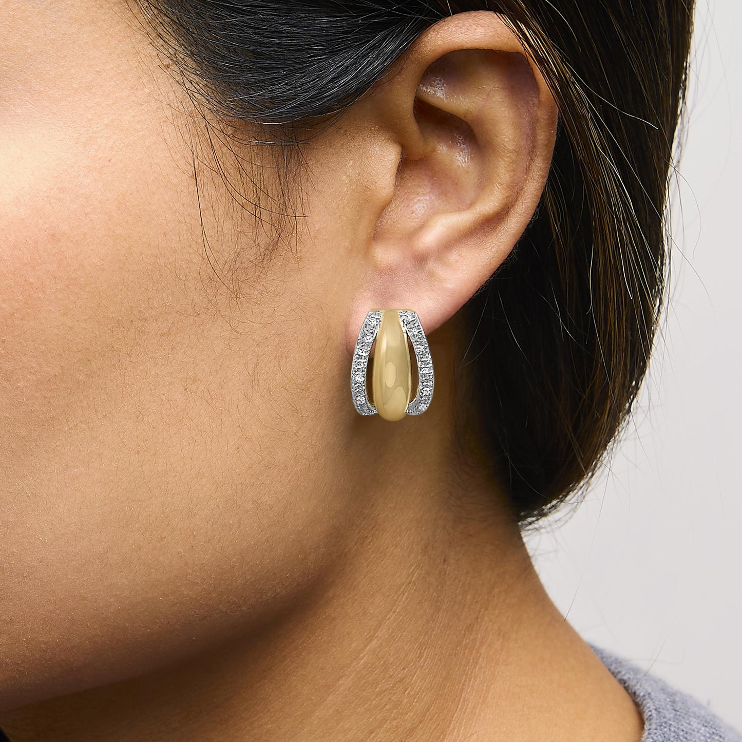 Close-up side view of Gold Vermeil half-hoop earring worn on model’s ear showing smooth center and pave-set white diamonds