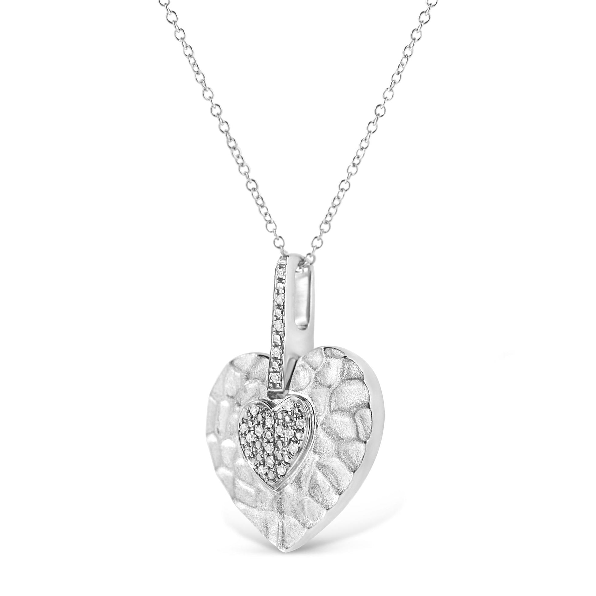 White metal heart-shaped necklace pendant with a smaller heart featuring white gemstones in pave setting, shown in a front angle view.