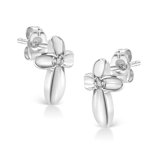 Front angled view of white metal flower-shaped stud earrings with small white gemstones in the center.
