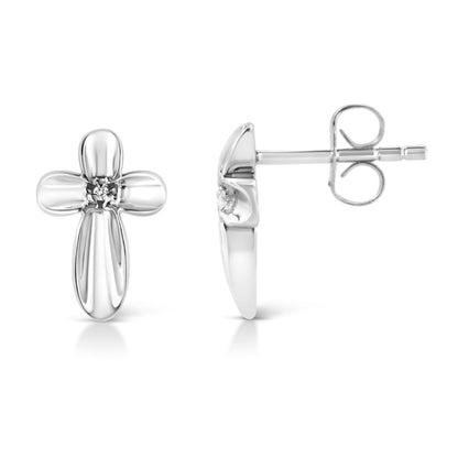 Front and side view of white metal cross-shaped earrings with a round white gemstone in prong setting at the center, against a white background.