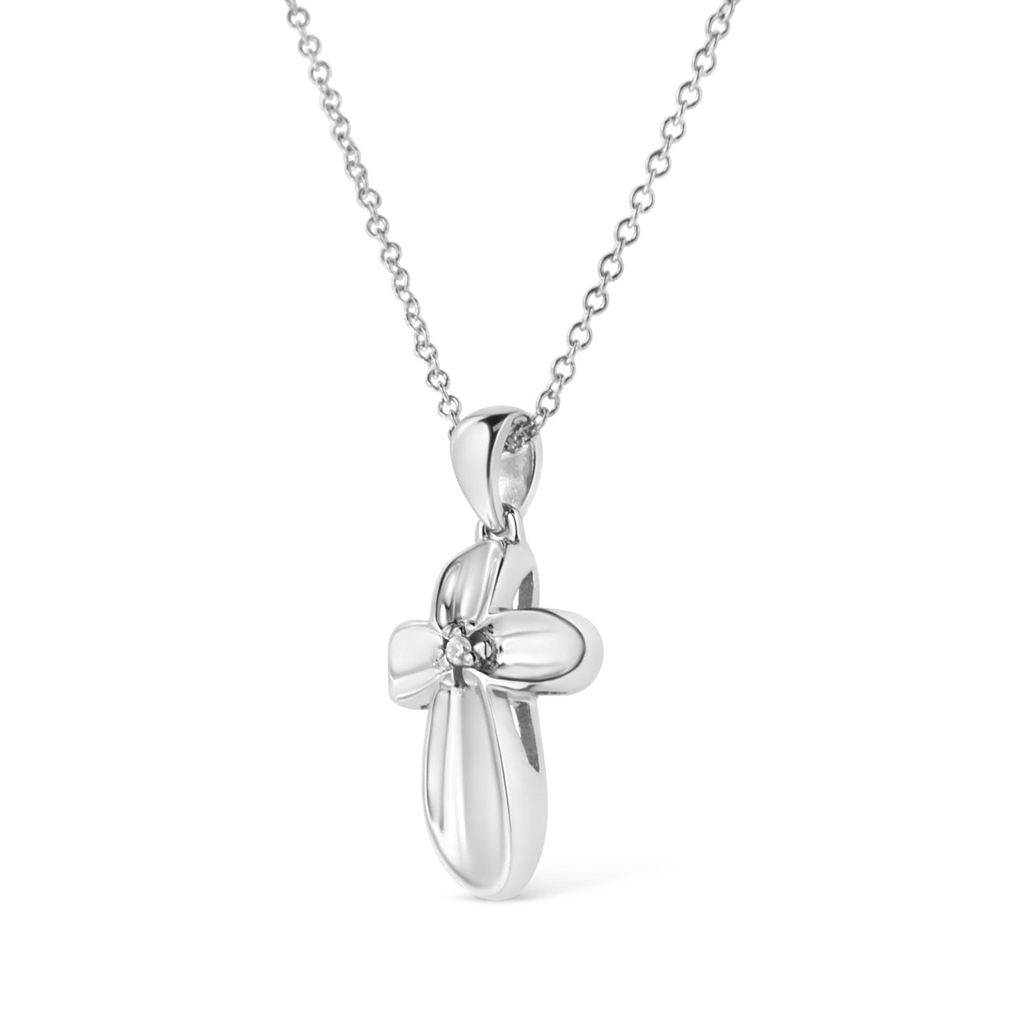 Front angled view of a white metal cross-shaped necklace pendant with a round white gemstone in a prong setting at the center, hanging from a chain.