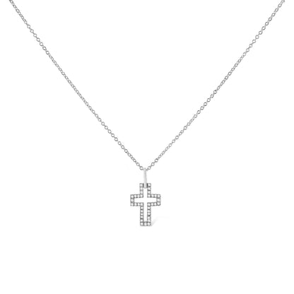 Front-facing shot of a white metal necklace with a cross-shaped pendant outlined with round white gemstones in a pave setting.