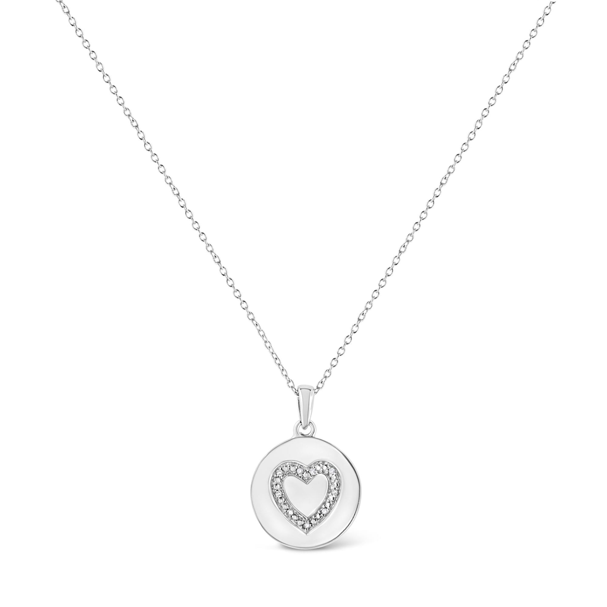 White metal necklace with a round pendant featuring a heart outline set with round white gemstones, shown from the front.