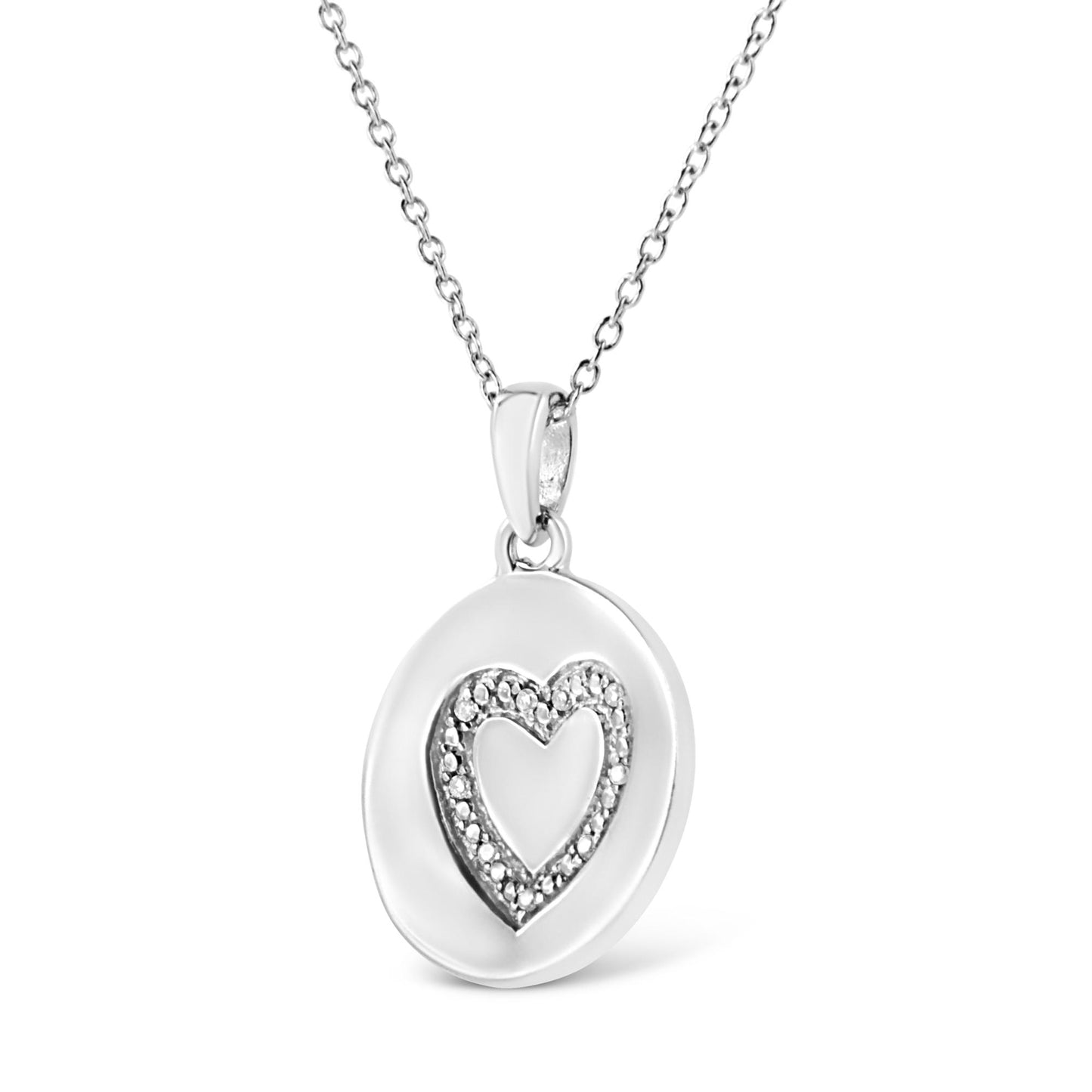 Front angled view of a white metal necklace with a round pendant featuring an inner heart shape outlined with small white gemstones in prong settings.
