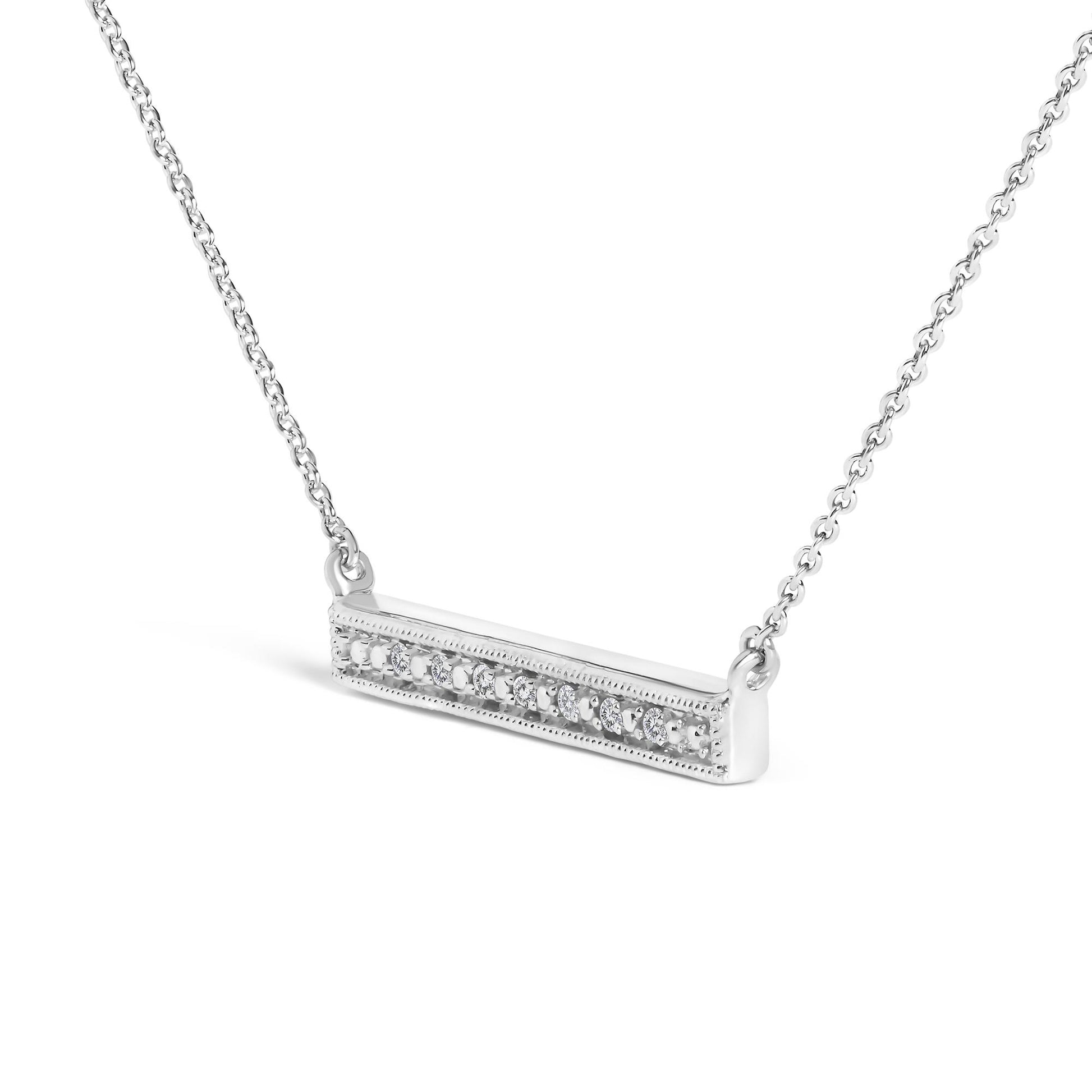 Close-up angled view of a white necklace with a horizontal rectangular pendant featuring a row of round white gemstones in prong settings.