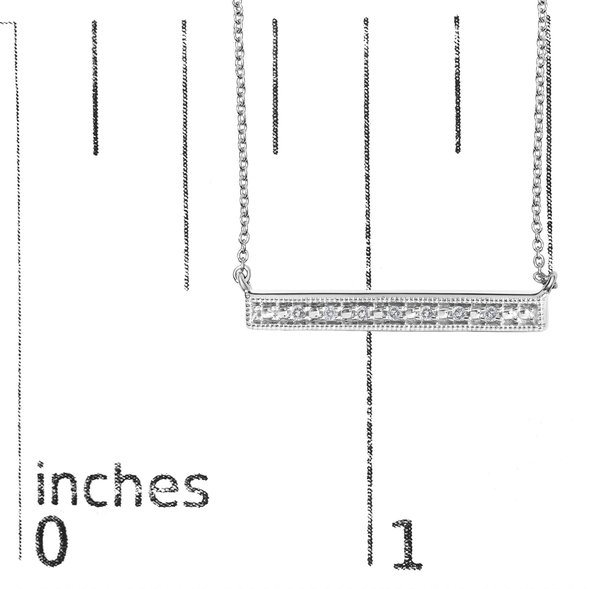 Close-up front view of a white metal bar necklace with a row of round white gemstones set in prongs, displayed on a measurement scale.
