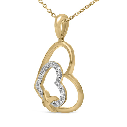 Close-up front angle of a yellow metal necklace pendant with an abstract open shape encrusted with small round white gemstones in a pave setting.