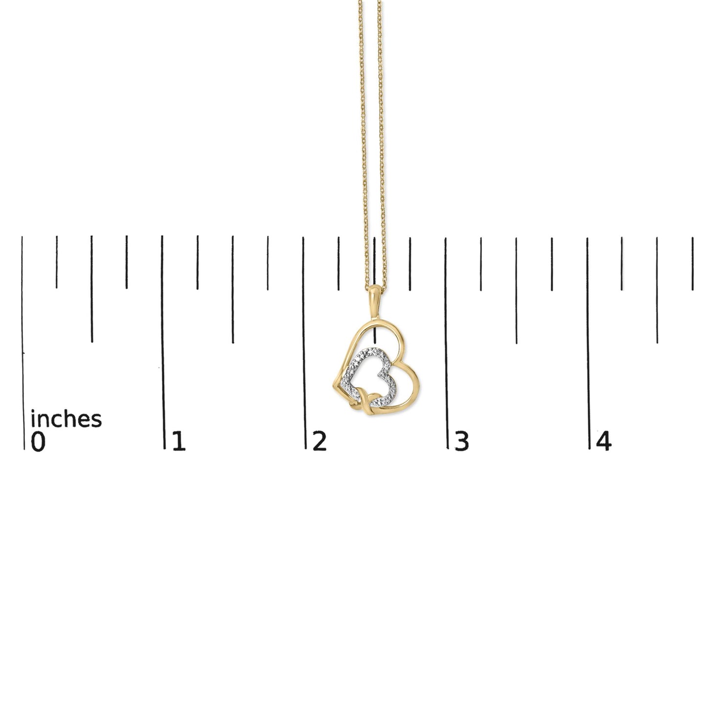 Yellow metal necklace with overlapping heart pendant, one heart outlined with white gemstones in pave setting, shown on a scale, front view.