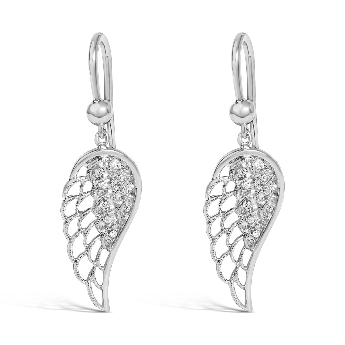 Close-up front angle of a pair of white metal drop earrings with an intricate wing-shaped design featuring pave-set round white gemstones.