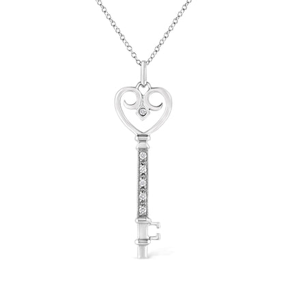 Front view of a white metal key-shaped necklace pendant with a heart-shaped top featuring one round brownish gemstone in bezel setting and a vertical bar adorned with round brownish gemstones in pave setting, hanging from a chain.