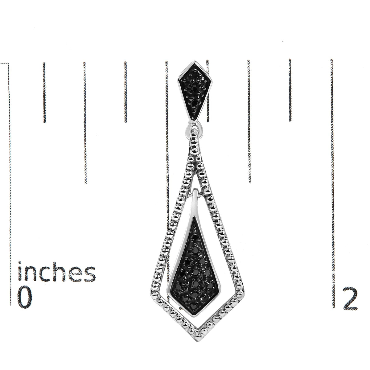 Close-up front view of a white-colored earring with black gemstones in pave setting, shown on a scale.