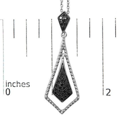 Close-up front view of a white metal necklace pendant featuring geometric shapes decorated with round black gemstones in pave setting, shown on a measurement scale.