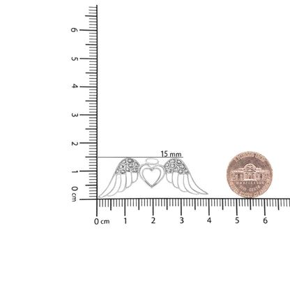 Front view of white necklace pendant shaped like a heart with wings adorned with pave-set round white gemstones, placed on a ruler and next to a coin for size reference.